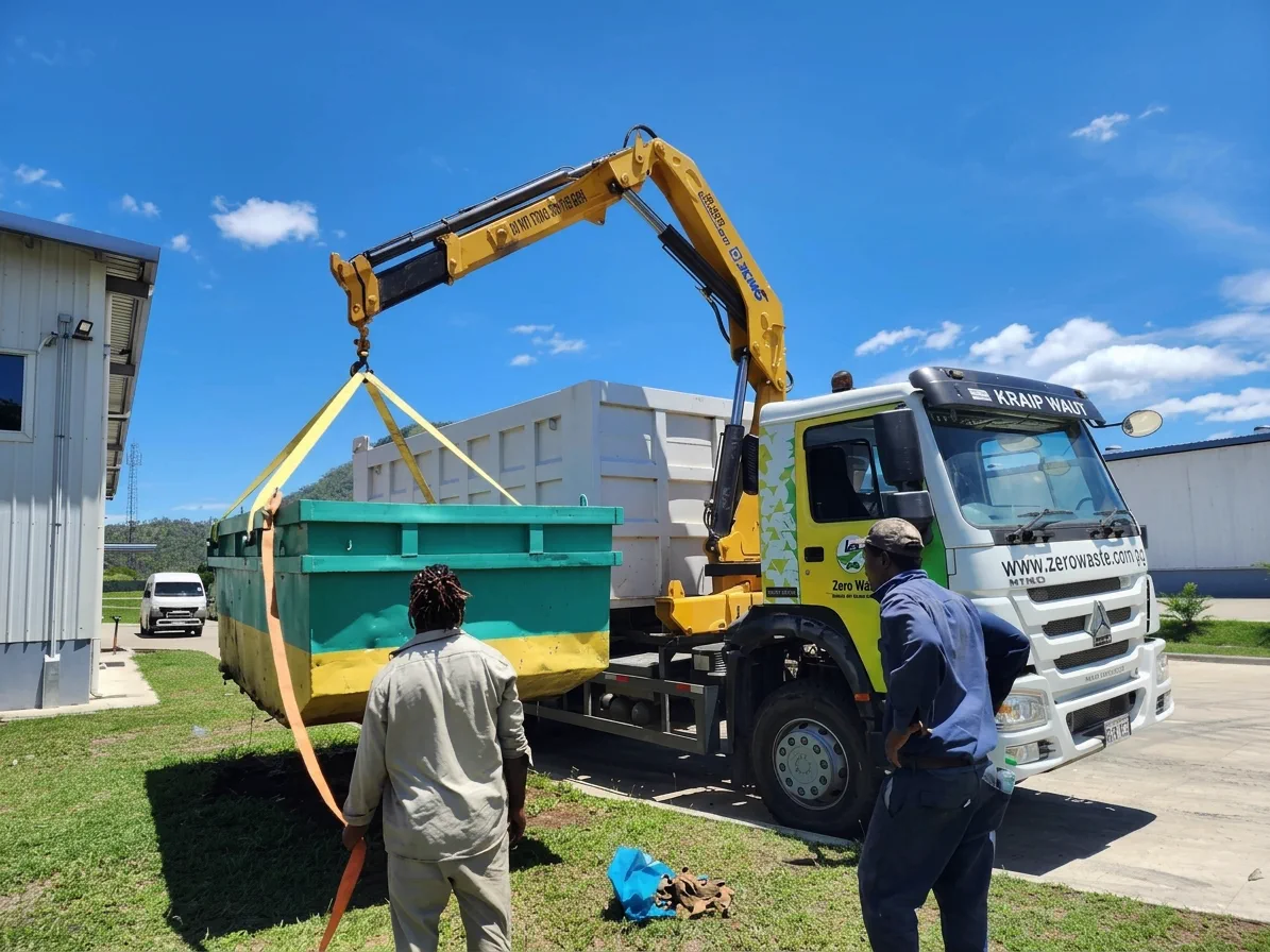 Crane truck servicing a collection site